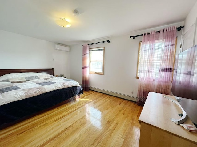 bedroom featuring a wall mounted air conditioner, light wood finished floors, and baseboard heating