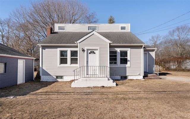 bungalow with a chimney, a front lawn, and roof with shingles