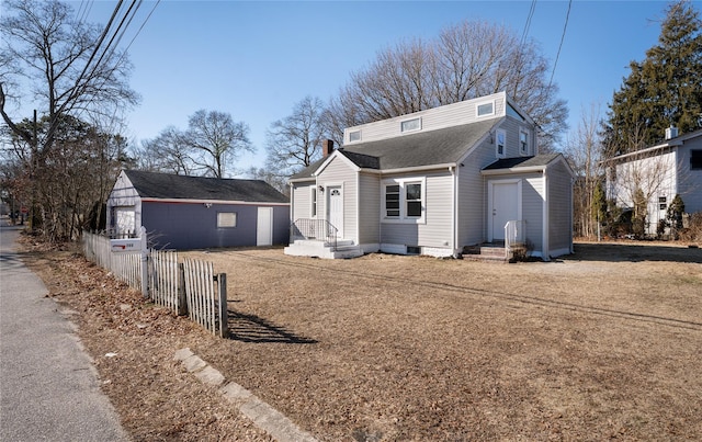 view of front of home featuring fence and roof with shingles