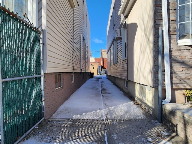 view of property exterior featuring a patio area and fence