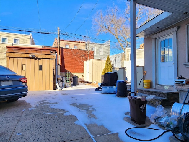 view of yard featuring an outbuilding, a patio, and a shed