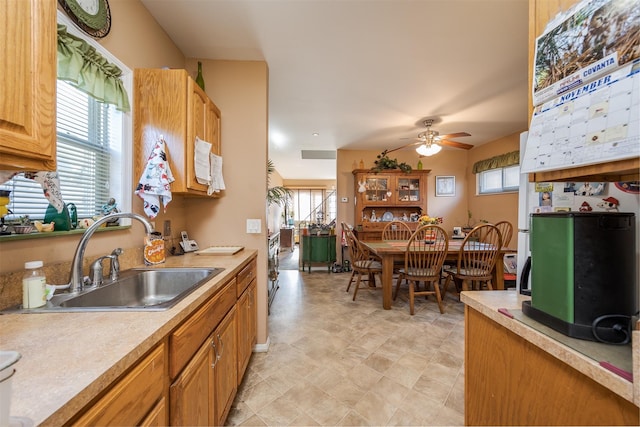 kitchen featuring light countertops, a sink, and a ceiling fan