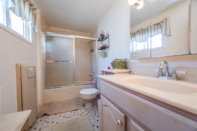 full bathroom with toilet, a healthy amount of sunlight, enclosed tub / shower combo, and vanity