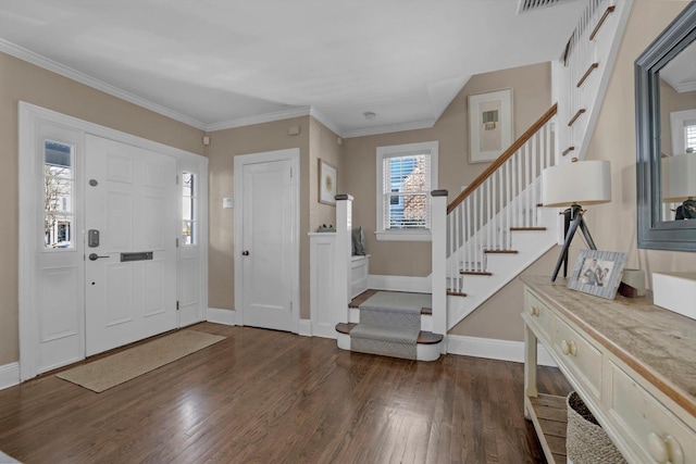 entrance foyer featuring ornamental molding, dark wood finished floors, stairway, and baseboards