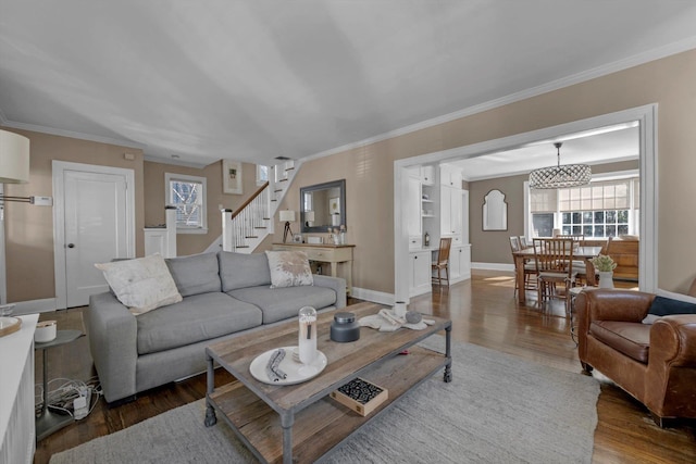 living room with dark wood-style floors, ornamental molding, stairway, and baseboards