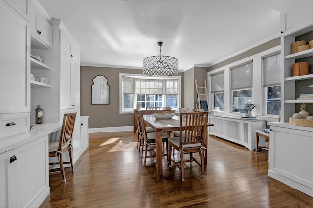 dining space with baseboards, radiator, dark wood-style floors, crown molding, and built in desk