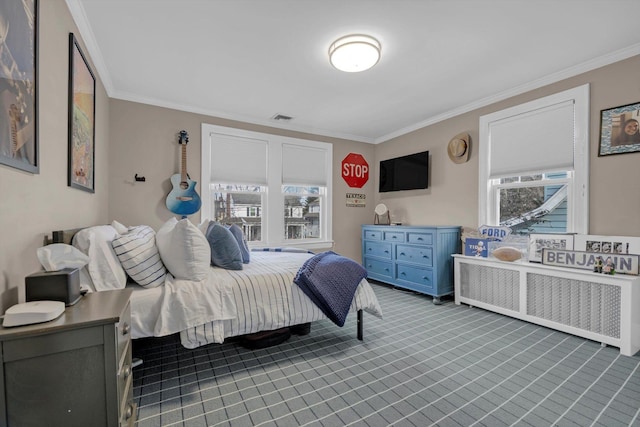 bedroom with crown molding, visible vents, and radiator