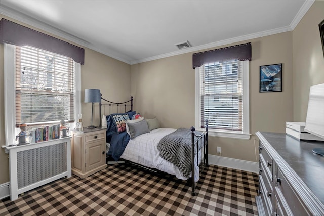 bedroom with ornamental molding, radiator, visible vents, and baseboards