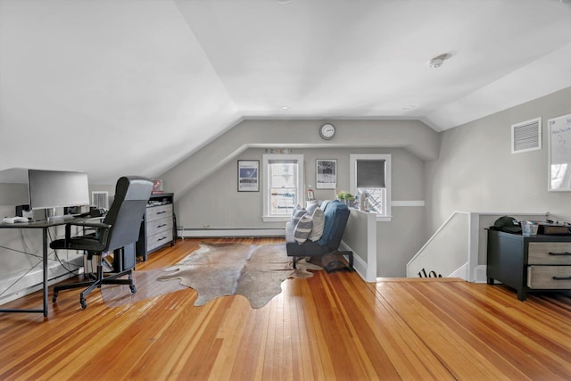 office area featuring baseboards, visible vents, a baseboard radiator, hardwood / wood-style floors, and vaulted ceiling