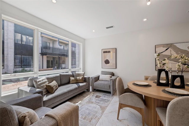 living area featuring recessed lighting, marble finish floor, and visible vents