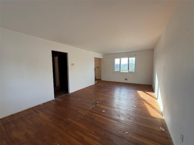 spare room featuring dark wood-type flooring