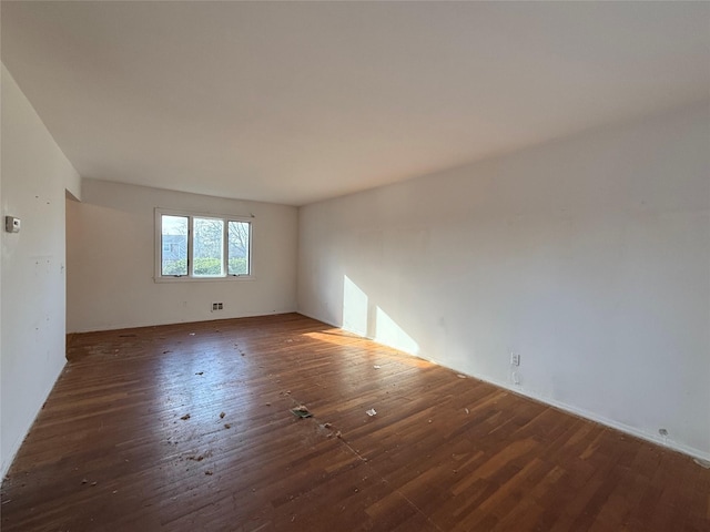 empty room featuring dark wood-style flooring