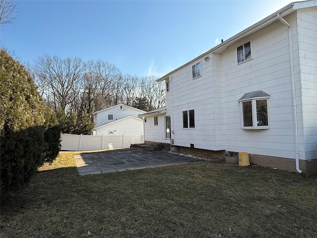 back of house featuring a patio area, fence, and a lawn