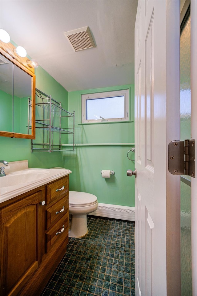 bathroom featuring visible vents, toilet, vanity, and baseboards