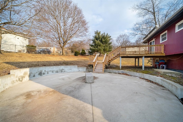 view of patio featuring a wooden deck and stairway