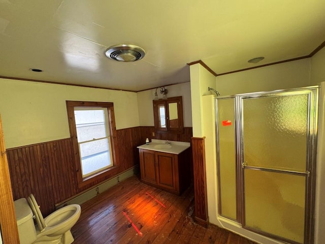 bathroom featuring wooden walls, a healthy amount of sunlight, a wainscoted wall, and a shower stall