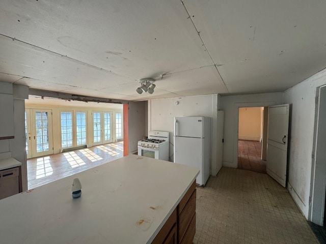 kitchen featuring white appliances and light countertops