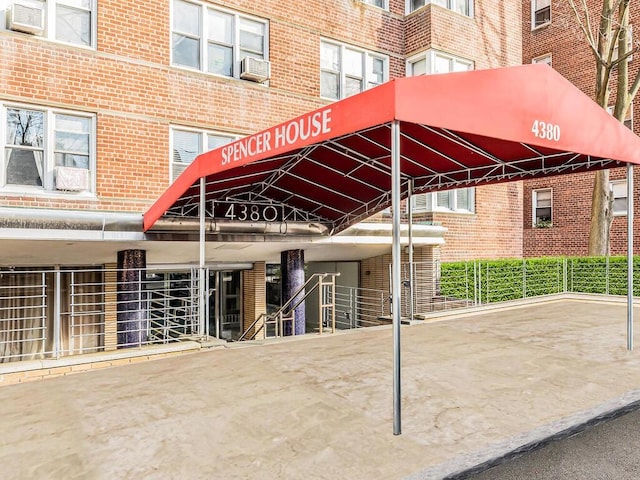 exterior space featuring cooling unit and brick siding