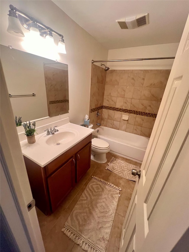 bathroom featuring shower / tub combination, toilet, vanity, visible vents, and tile patterned floors