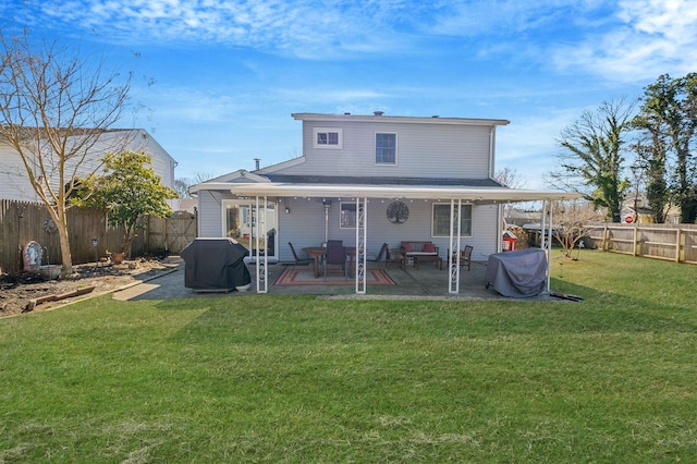 rear view of property with a yard, a patio, and a fenced backyard