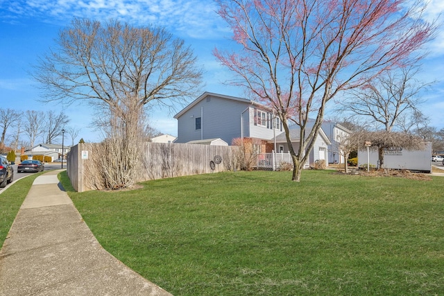 view of yard featuring fence and a residential view