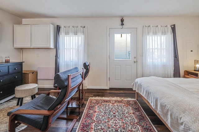 bedroom featuring dark wood finished floors and baseboards