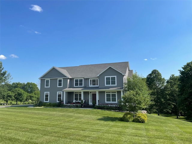 colonial house featuring a front lawn and a porch