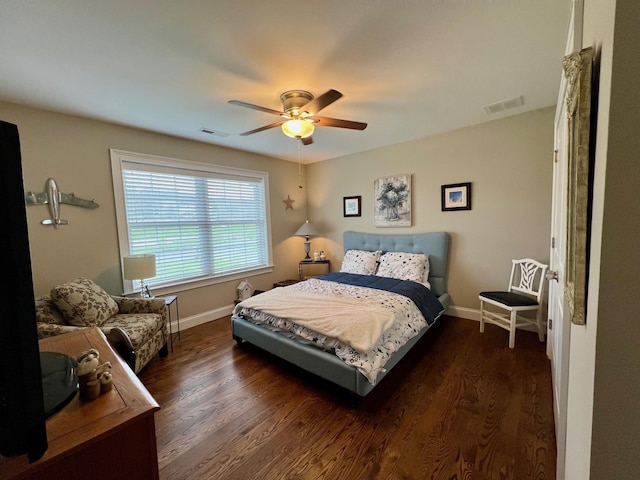 bedroom featuring wood finished floors, visible vents, and baseboards