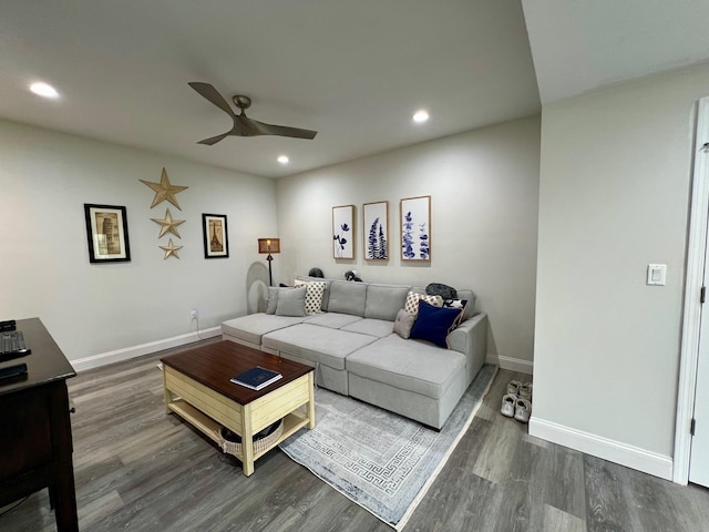 living area featuring recessed lighting, dark wood finished floors, and baseboards