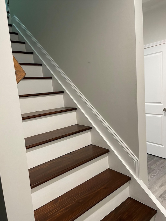 stairs featuring wood finished floors