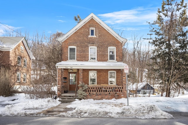 view of front facade featuring covered porch and brick siding