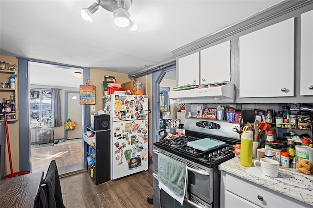 kitchen with range with two ovens, dark wood-type flooring, freestanding refrigerator, white cabinets, and under cabinet range hood