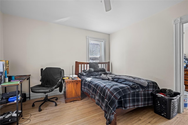 bedroom with ceiling fan and light wood-style flooring