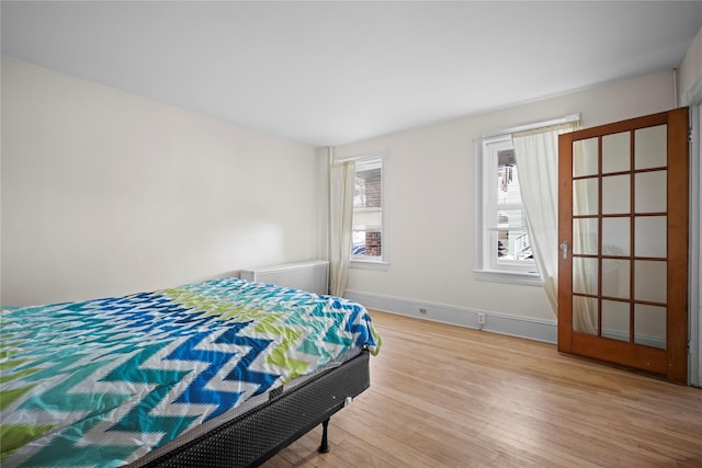 bedroom with wood finished floors and baseboards