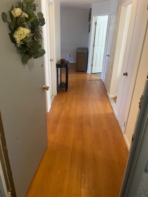 hallway featuring light wood-style flooring