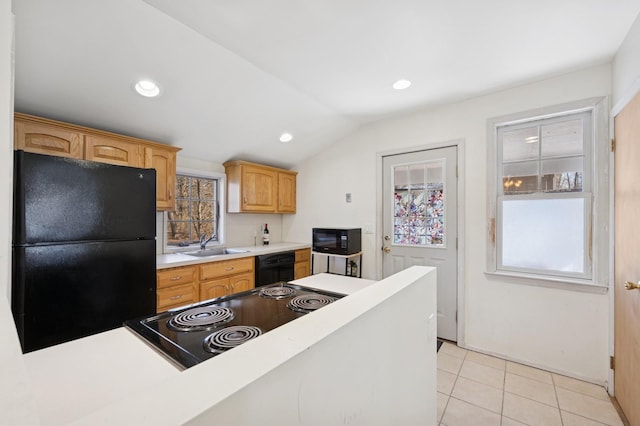 kitchen featuring light tile patterned flooring, recessed lighting, a sink, light countertops, and black appliances