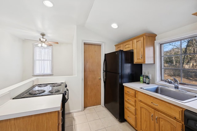 kitchen featuring light tile patterned floors, black appliances, a sink, and light countertops