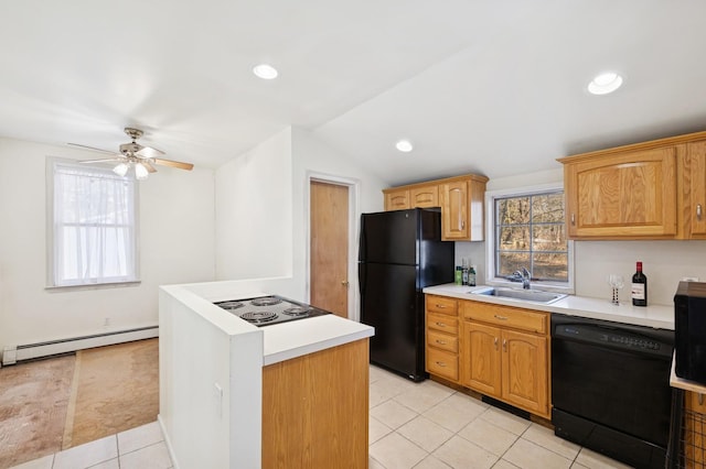 kitchen with a baseboard radiator, a sink, a healthy amount of sunlight, light countertops, and black appliances