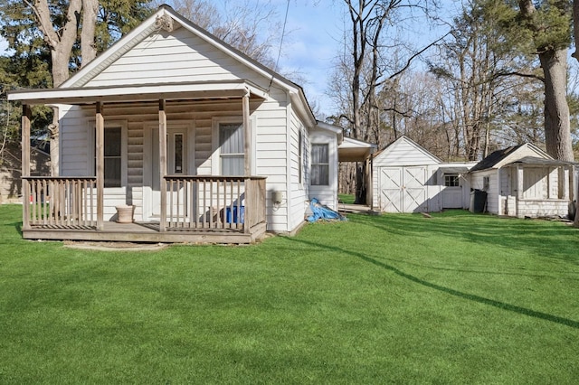 back of property featuring a storage unit, a lawn, and an outdoor structure