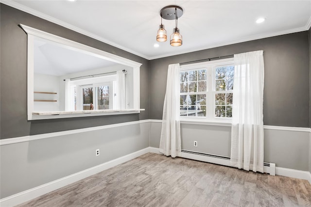 interior space featuring baseboards, a baseboard radiator, wood finished floors, and a healthy amount of sunlight