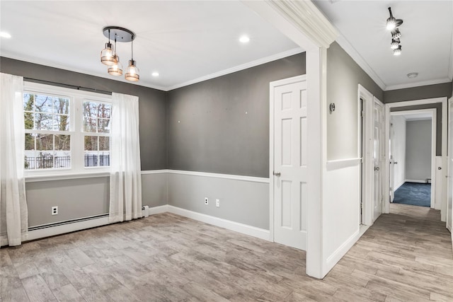 unfurnished dining area featuring recessed lighting, ornamental molding, a baseboard heating unit, wood finished floors, and baseboards