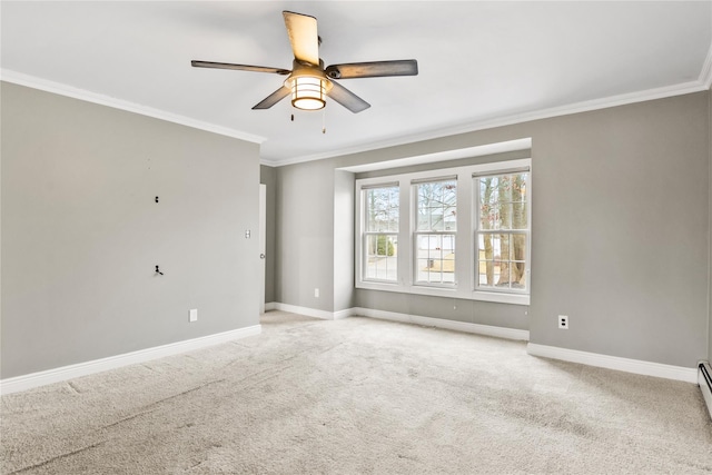 empty room featuring ornamental molding, carpet flooring, a ceiling fan, and baseboards