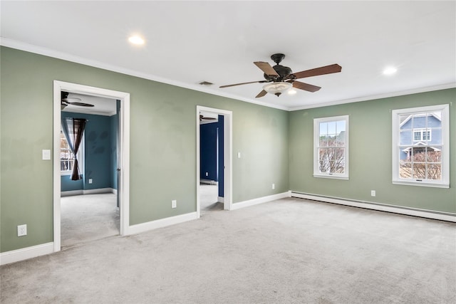 empty room featuring ornamental molding, baseboard heating, and carpet flooring