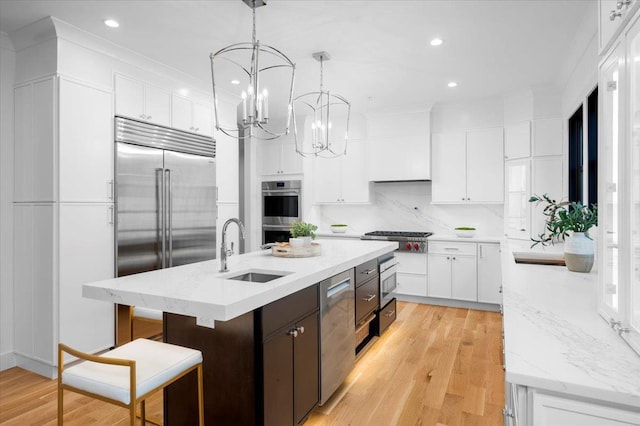12 Fairway Ave, Rye, NY 10580 - kitchen with a sink, appliances with stainless steel finishes, white cabinetry, light wood-style flooring, and recessed lighting