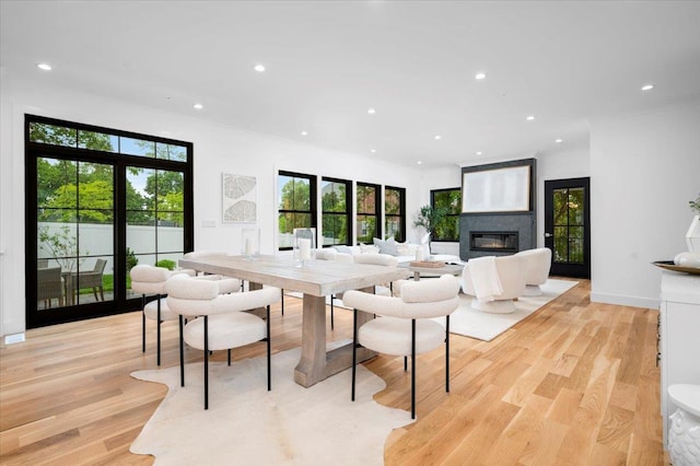 12 Fairway Ave, Rye, NY 10580 - dining area with recessed lighting, light wood finished floors, a glass covered fireplace, and healthy amount of natural light