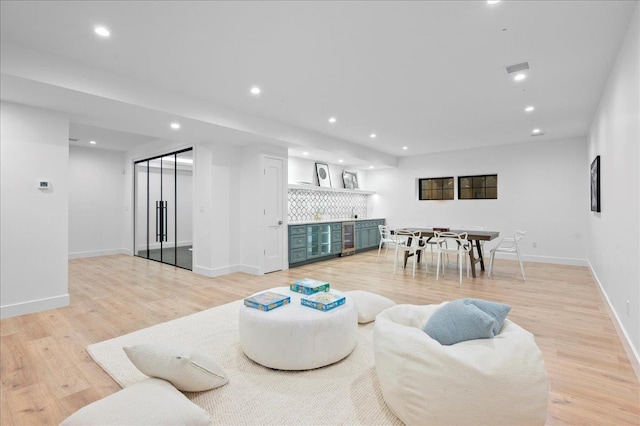 12 Fairway Ave, Rye, NY 10580 - living room with bar, recessed lighting, light wood-type flooring, baseboards, and beverage cooler