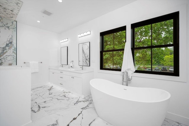 12 Fairway Ave, Rye, NY 10580 - bathroom featuring marble tiled flooring, healthy amount of natural light, double vanity, a freestanding tub, and recessed lighting