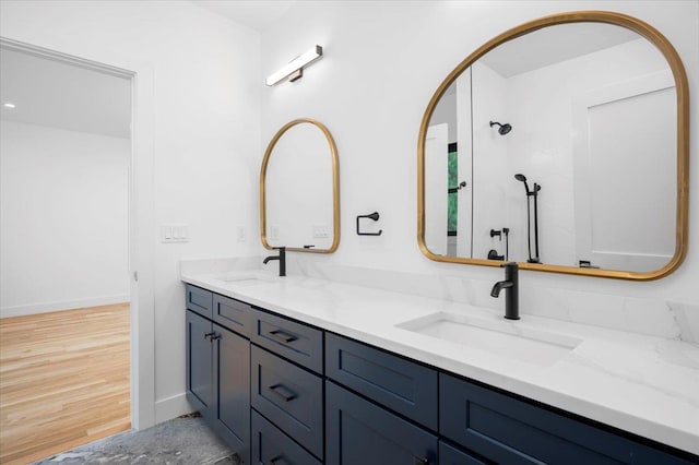 12 Fairway Ave, Rye, NY 10580 - bathroom with wood finished floors, double vanity, baseboards, and a shower
