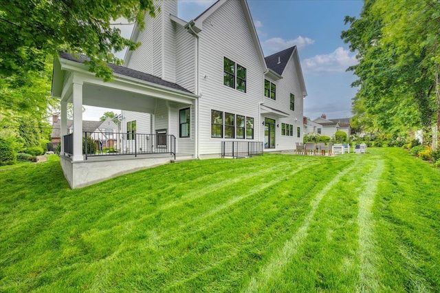 12 Fairway Ave, Rye, NY 10580 - rear view of house featuring a patio area, a lawn, and a chimney