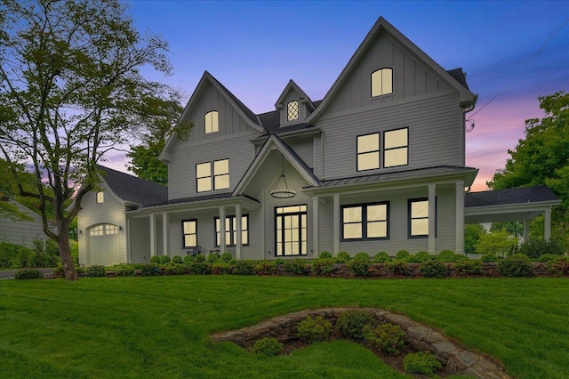 12 Fairway Ave, Rye, NY 10580 - back of property at dusk with board and batten siding, a standing seam roof, a yard, metal roof, and a porch
